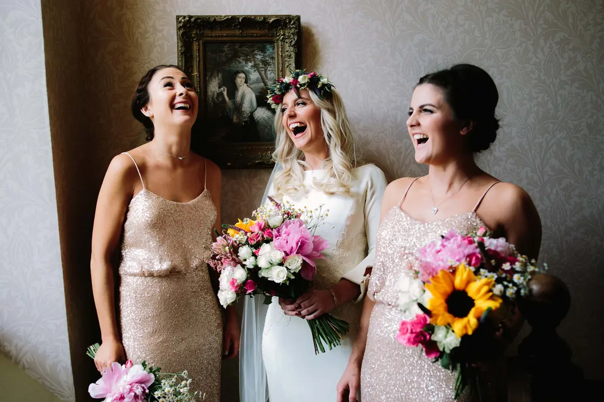 Bride laughing with her bridesmaids at Oxford Weddings