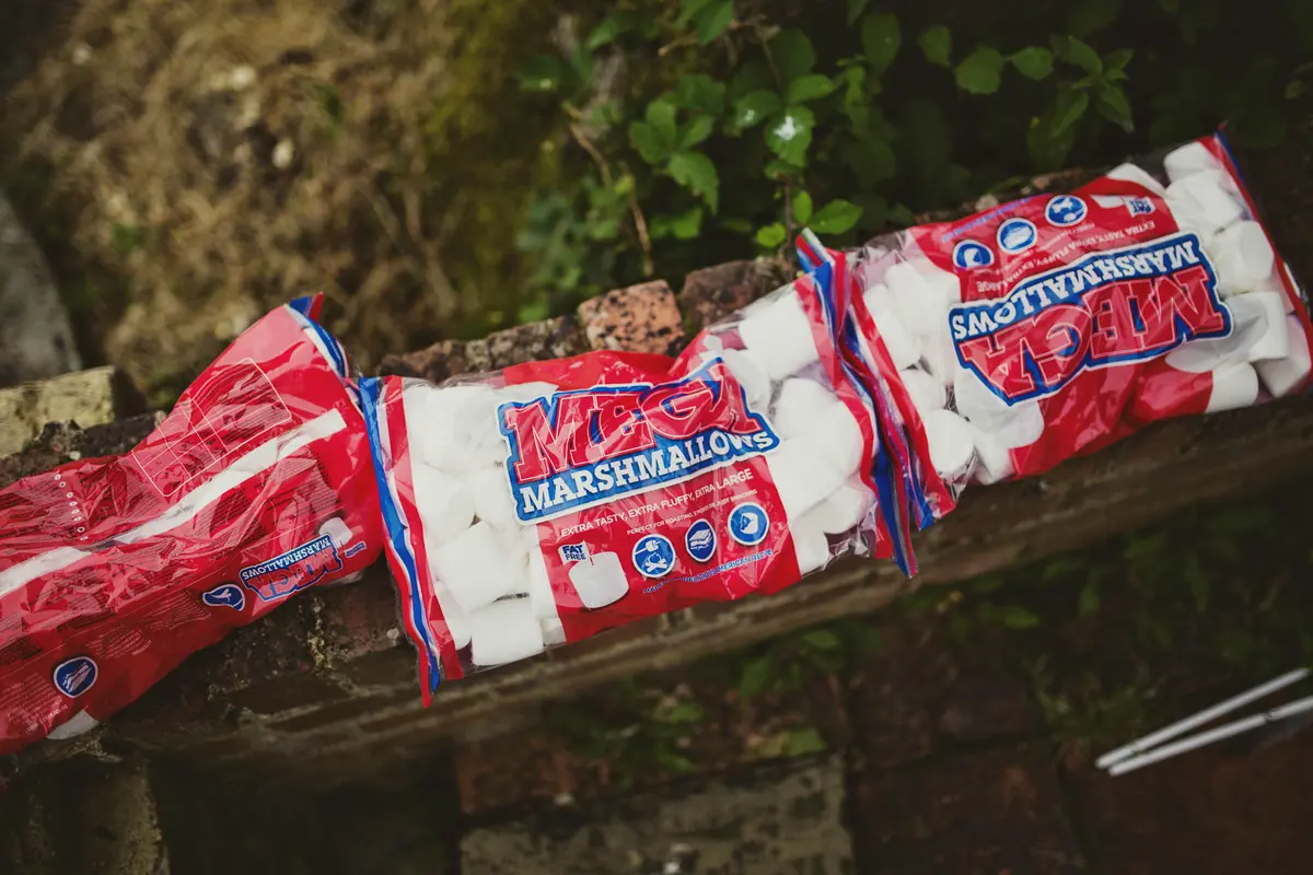 Bags of giant marshmallows lined up on a garden wall