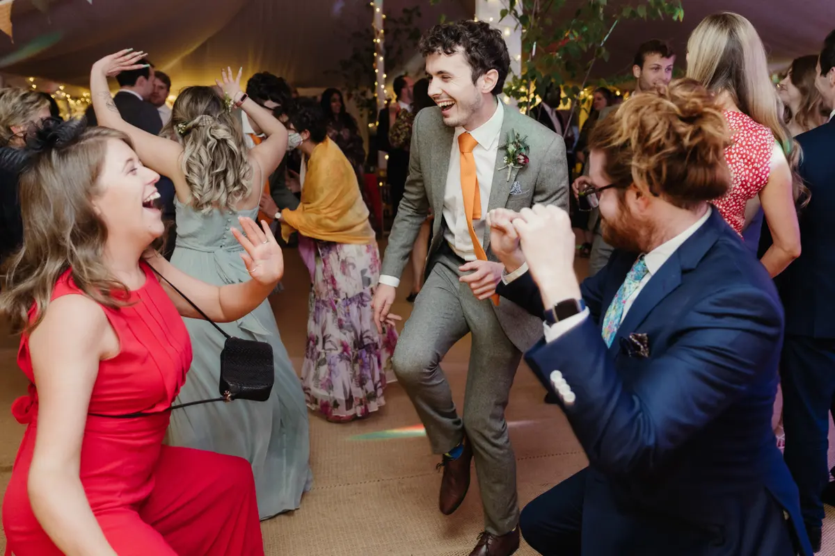 Guests laughing and dancing on the dance floor in the marquee at the Perch