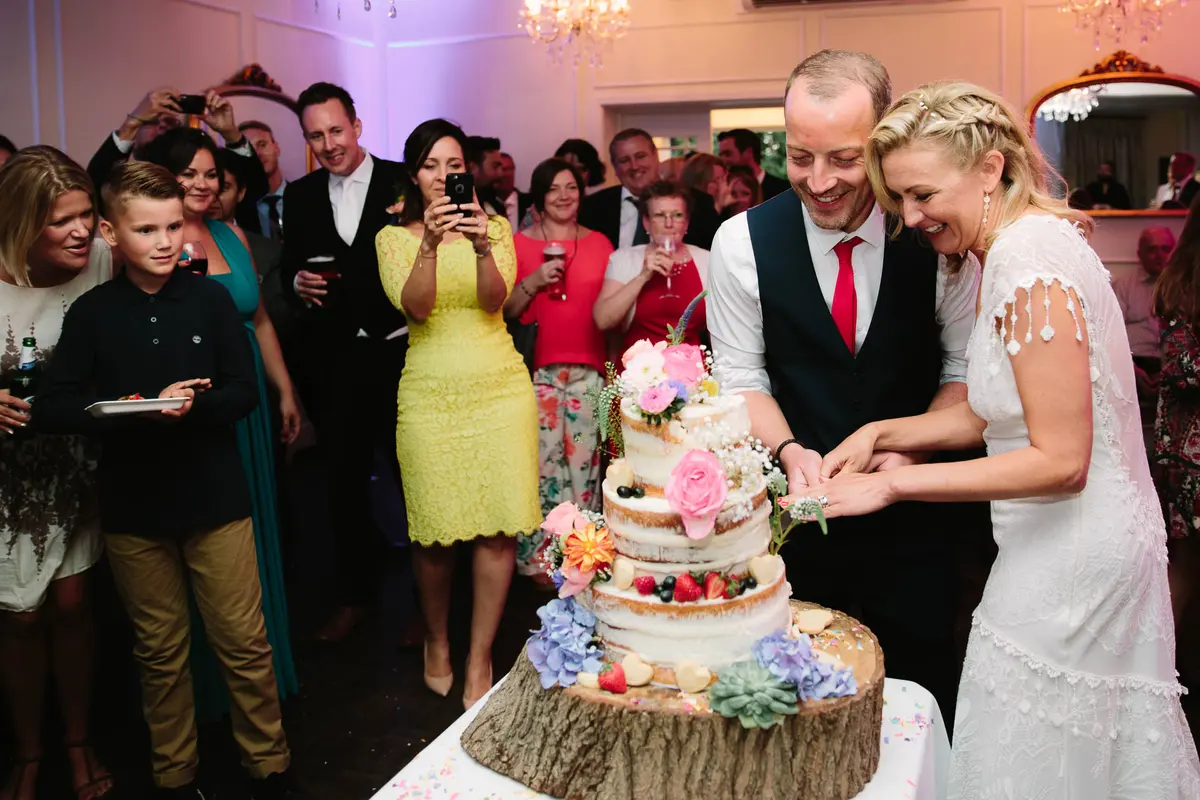 Bride and Groom cutting cake shot by Oxford Wedding Photographer