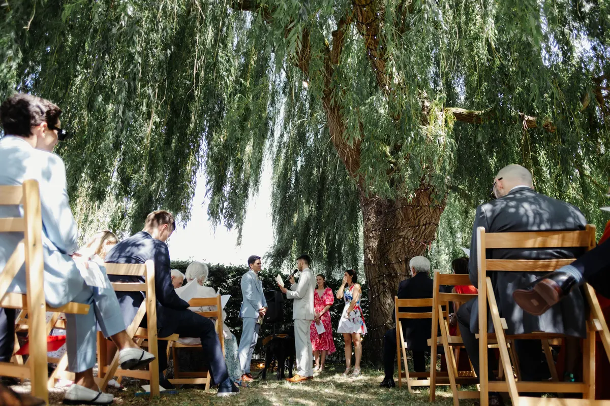 Pedro and Joe wedding ceremony under willow tree at The Perch Oxford