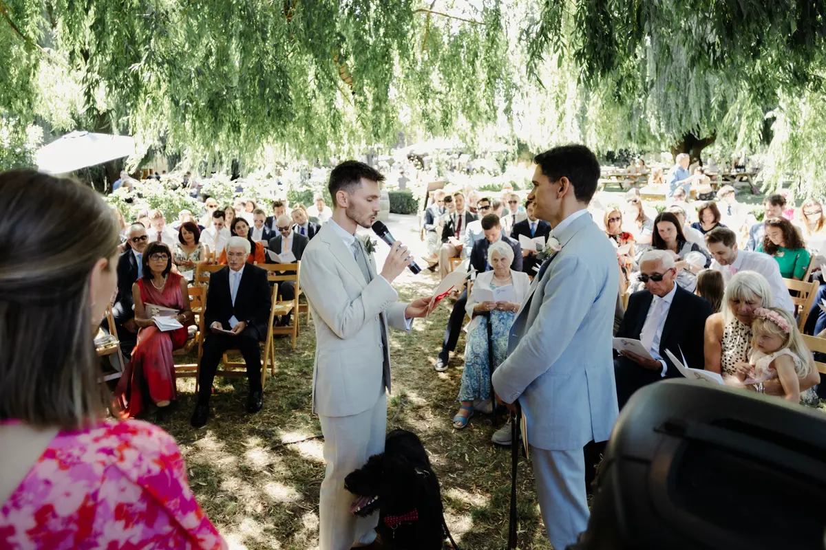 Couple exchanging vows under willow tree The Perch Oxford wedding