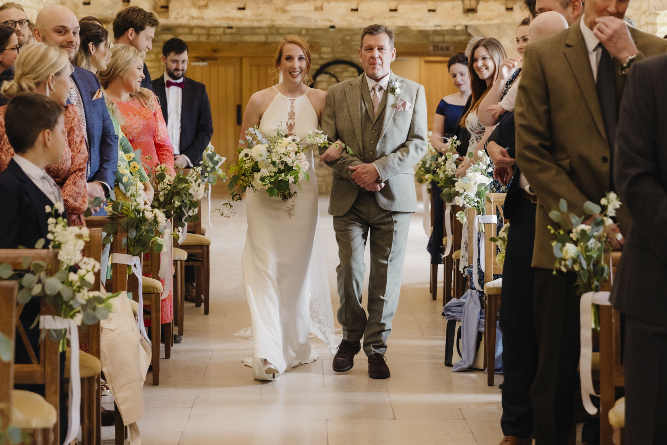 bride walking down isle at Caswell House Barn